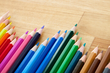 Line of Colorful Pencils on Wooden Table