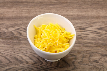 Shredded yellow cheese in the bowl