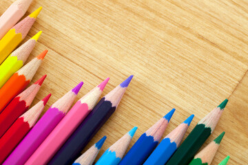 Line of Colorful Pencils on Wooden Table with Copy Space