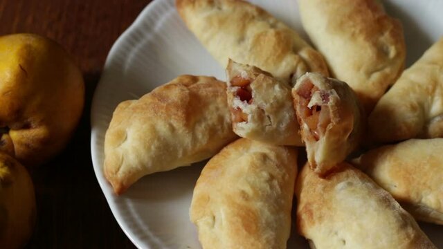 Panzerotti of puff pastry filled with diced quince apples
