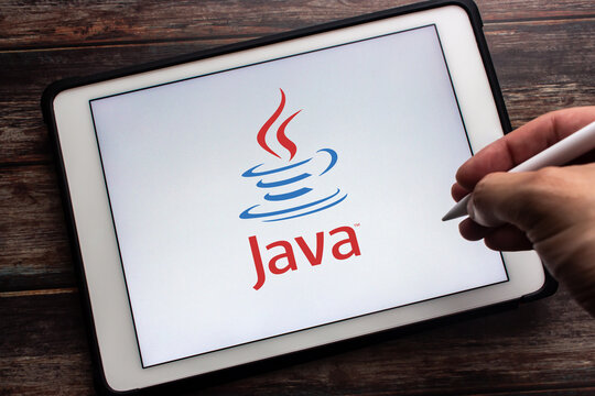 Kumamoto, JAPAN - May 13 2021 : Closeup logo of Java on tablet. Java is the popular class-based, object-oriented programming language. Man hand holding wireless stylus pen.