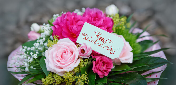 Valentine's day greeting card with flowers bouquet on wooden background.