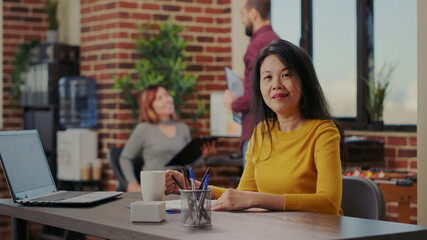 Portrait of person analyzing company paperwork for innovation, working with statistics documents to plan entrepreneurship. Woman using financial analysis to develop business career.