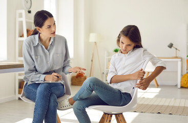 Young female psychologist talk with girl teenager suffering from bullying in school feeling depressed. Caring woman social worker have meeting with teen schoolgirl depression or adolescence crisis. - obrazy, fototapety, plakaty