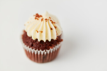 Small cupcake with cream as a topping