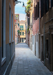 Fototapeta na wymiar Colorful houses in the old medieval street in Venice, Italy