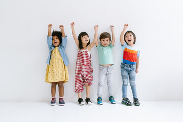 Fototapeta Group of Diverse Ethnicity Little kids raising hands up and smiling Isolated on gray background. Childhood, freedom, happiness, active lifestyle concept. obraz