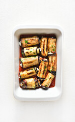 Baked eggplant rolls with tomato sauce and cheese