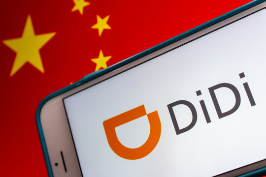 Kumamoto, JAPAN - Jul 7 2021 : Closeup DiDi logo on iPhone on Chinese flag. DiDi is a Chinese vehicle for hire company with over 550 million users and tens of millions of drivers