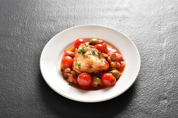 Cod stew with chickpeas, cherry tomatoes and olives