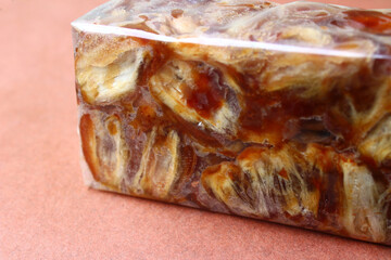 Packed seedless wet dates on brown background 