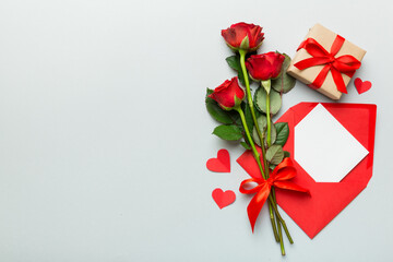 Valentine day composition with Envelope, rose flower and Red heart on table. Top view, flat lay. Holiday concept