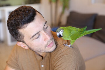 Ethnic man with a traditional green parrot © ajr_images