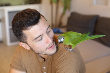 Ethnic man with a traditional green parrot © ajr_images