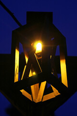 The Old Мedieval Wooden Frame Lamp with the Yellow Light on the Night Sky Background