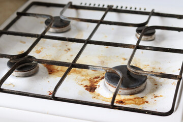 Dirty gas stove with food debris and grease stains. A dirty gas stove with grease stains, old...