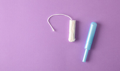 Absorbent protective tampon for women care on lilac background