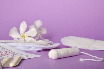 Group of products for menstrual hygiene close up lilac background