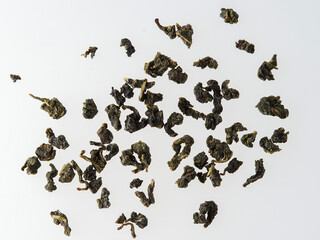 Dry tea leaves isolated on a white background.