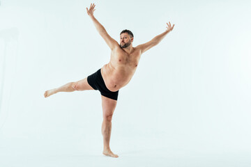 Man posing for a male edition body positive beauty set. Shirtless guy wearing boxers underwear in...