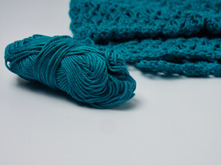 Wool yarn in different colors with wooden double point needles. The needles are being used for knitting socks, mittens or other projects joined in the round.