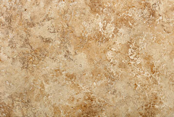Beige stone texture and background with spots and cracks.