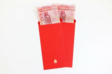 Chinese New Year lucky red envelopes with 100 Chinese Yuan inside, on white background