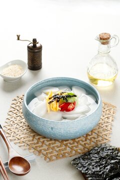 Korean Traditional Rice Cek Soup or Tteokguk, SLiced Ricek Cake Bar served with Beef Broth