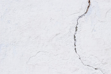 White old stone wall wit big crack as background. Selective focus. Grunge vector background.White background