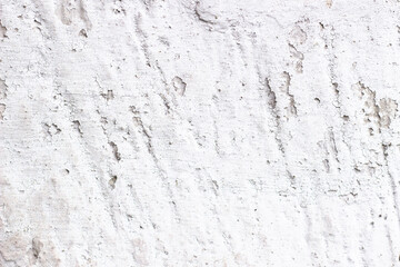 White peeled cracked stone wall as background. Selective focus. Grunge vector background.
