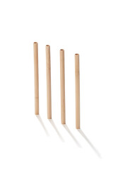 Detailed shot of reusable bamboo straws. The straws are made of light natural wood. The set of eco-friendly cocktail straws is located on the white background.