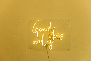 Neon words on the wall. Good vibes only neon sign at the bar, cafe or at home.