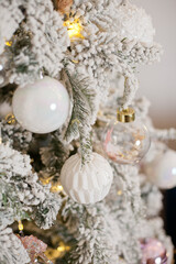 Snowy vintage christmas tree decorations with white baubles ornaments