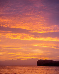 Sunset over the sea with a person