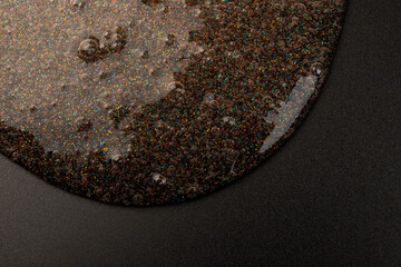 Coral transparent slime with bubbles inside on black background. Kids toy slime.