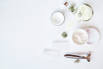 Face care cosmetics set on white background. Alginate mask, face cream and massager. Natural eco...