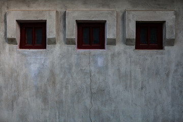 old stone building with three small windows