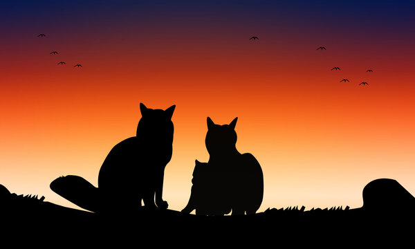Silhouette of a couple of cats on a sunset background