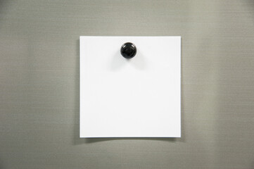 note paper with black pin on gray board