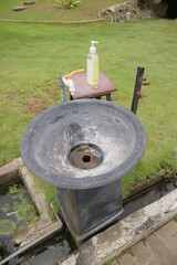round hand wash basin on the edge of the garden