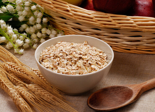Oatmeal cereal dish and ears of corns on fruit ingredients background.
