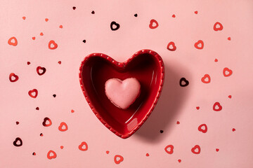 Romantic setup: heart shaped macaron in a heart shaped bowl