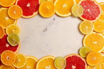 Background of juicy fresh bright citrus fruits, sliced flat lay - oranges, grapefruits, tangerines, lemons, limes, copy space