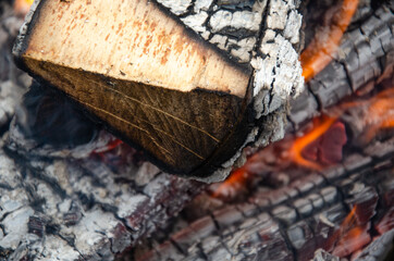 Burning firewood in the grill, bright coals and flames