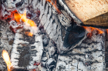 Burning firewood in the grill, bright coals and flames