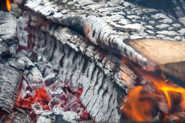 Burning firewood in the grill, bright coals and flames