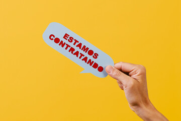 text we are hiring in spanish in a speech bubble