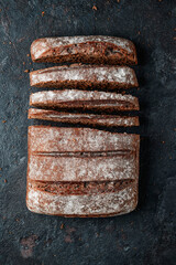 spanish rye bread loaf on a black stone surface