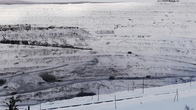 Open pit gold mining, dumpers, quarrying extractive industry stripping work. Opencast mining with lots of machinery trucks. Dump trucks loaded with iron ore on opencast