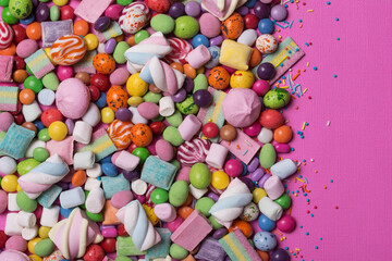 Fototapeta na wymiar Bright sweet multicolored dragee, candies, lollipops, marshmallows